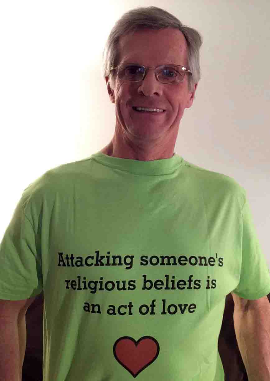 Darwin Bedford wearing his shirt that says 'Attacking someone's religious beliefs is an act of love'