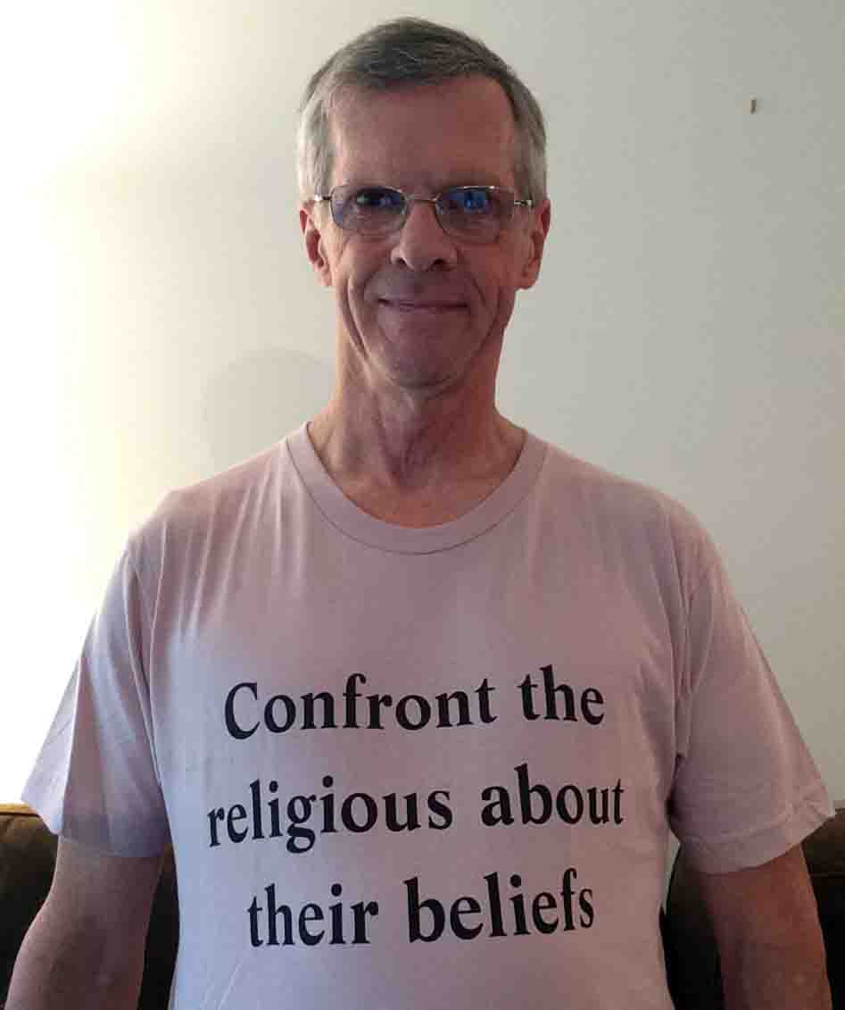 Darwin Bedford wearing his shirt that says 'Confront the religious about their beliefs'