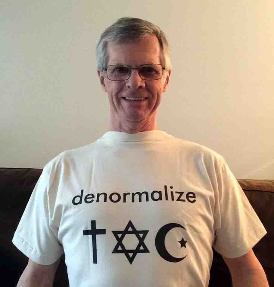 Darwin Bedford wearing his shirt that says 'Denormalize with symbols of religion'