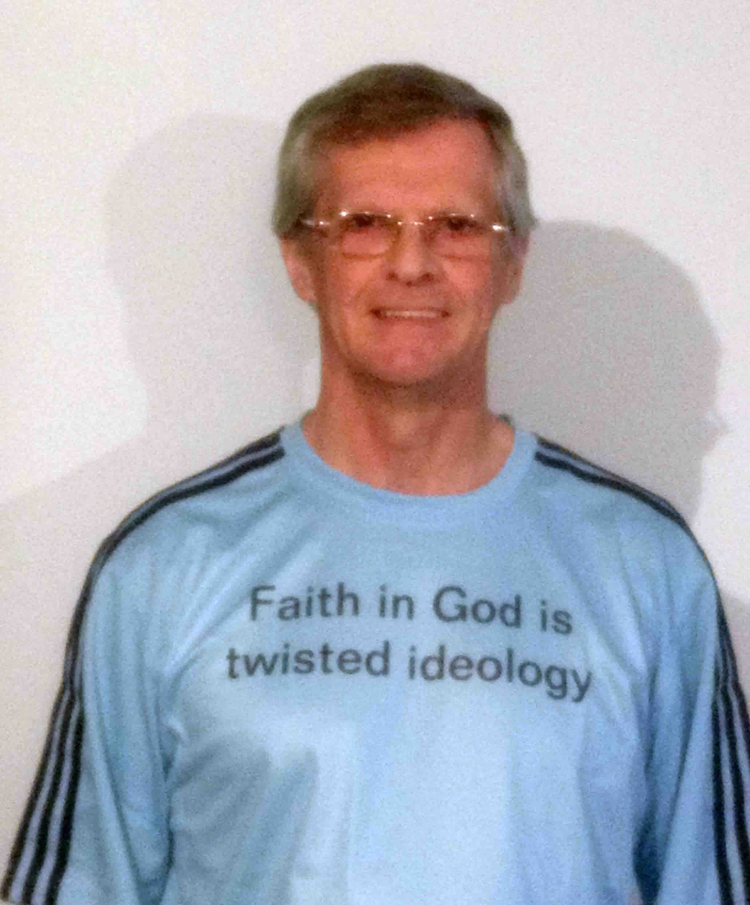 Darwin Bedford wearing his shirt that says 'Faith in God is twisted ideology'