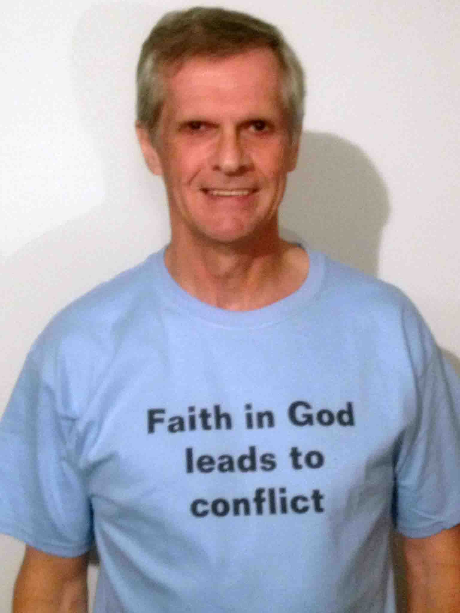 Darwin Bedford wearing his shirt that says 'Faith in God leads to conflict'