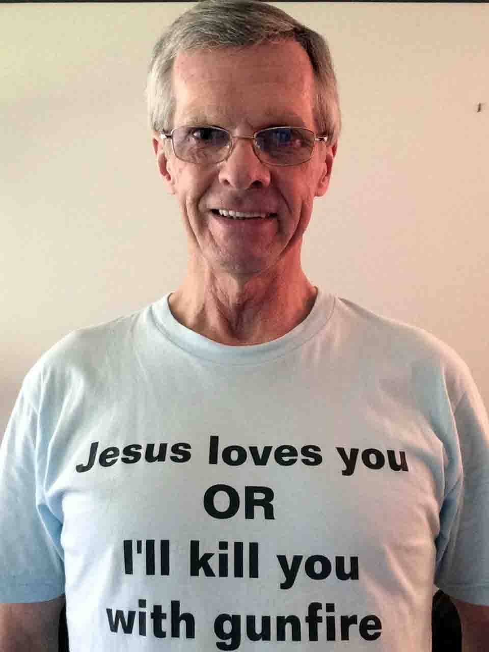 Darwin Bedford wearing his shirt that says 'Jesus loves you OR I will kill you with gunfire'