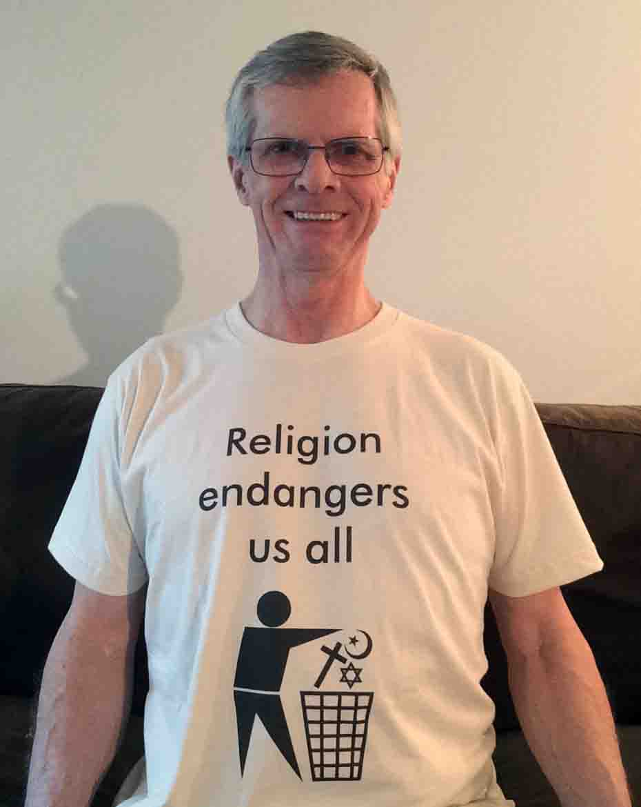 Darwin Bedford wearing his shirt that says 'Religion endangers us all with a trash sign'