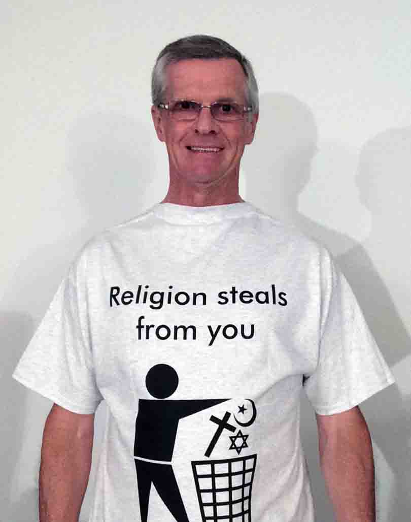 Darwin Bedford wearing his shirt that says 'Religion steals from you with a trash sign'