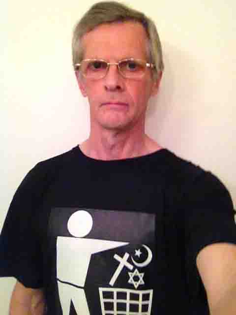 Darwin Bedford wearing a T-shirt depicting the international symbol for a wastes container with religious symbols in place of the wastes. 