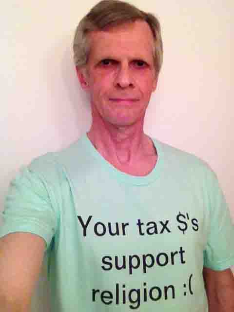 Darwin Bedford wearing his shirt that says 'Your tax $'s support religion :('