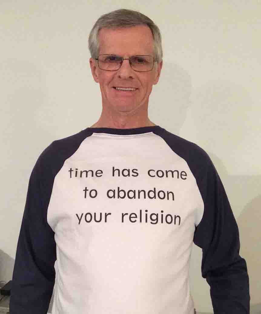 Darwin Bedford wearing his shirt that says 'time has come to abandon your religion'