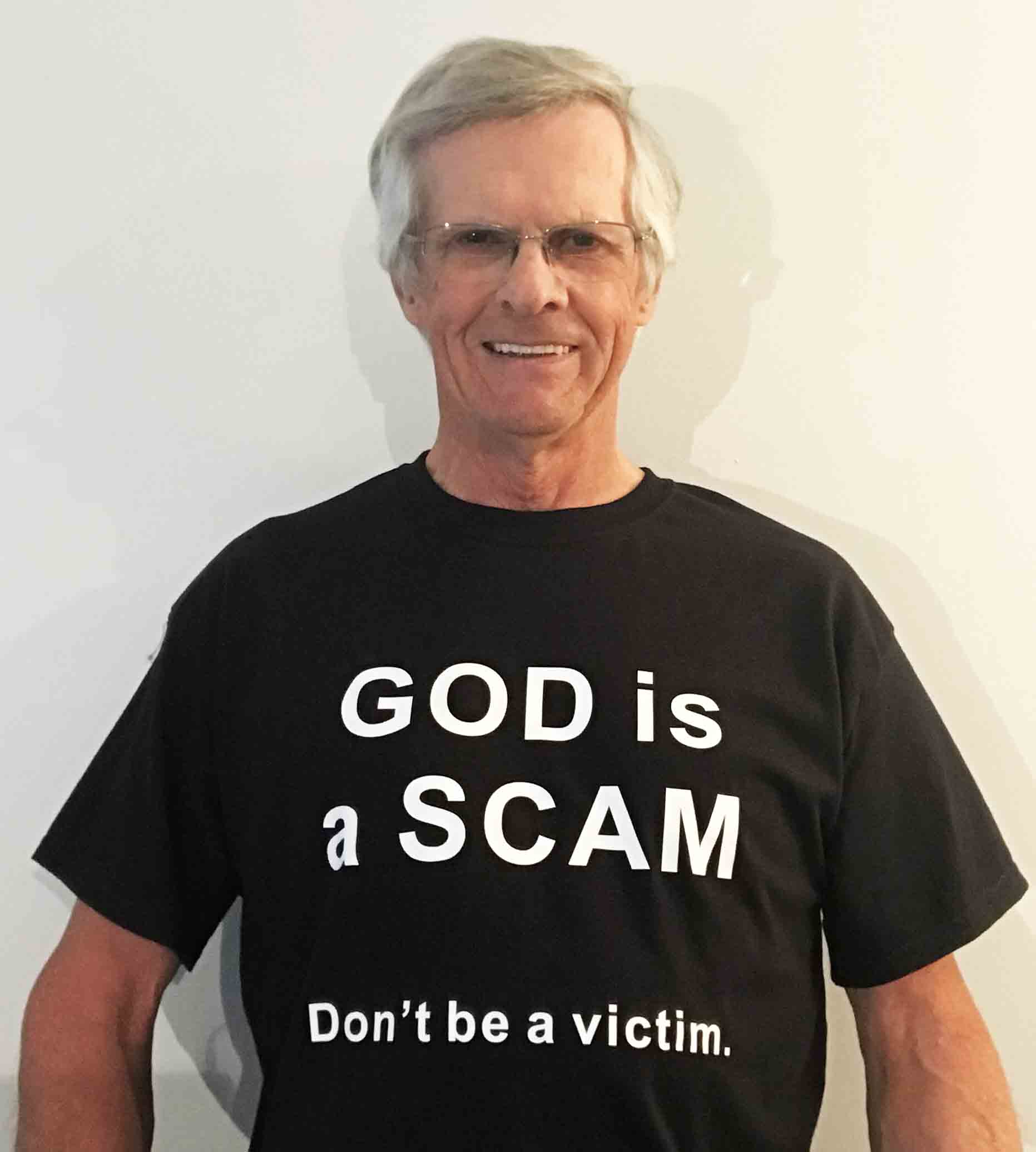 Darwin Bedford wearing his shirt that says 'GOD is a SCAM, Don't be a victim.'
