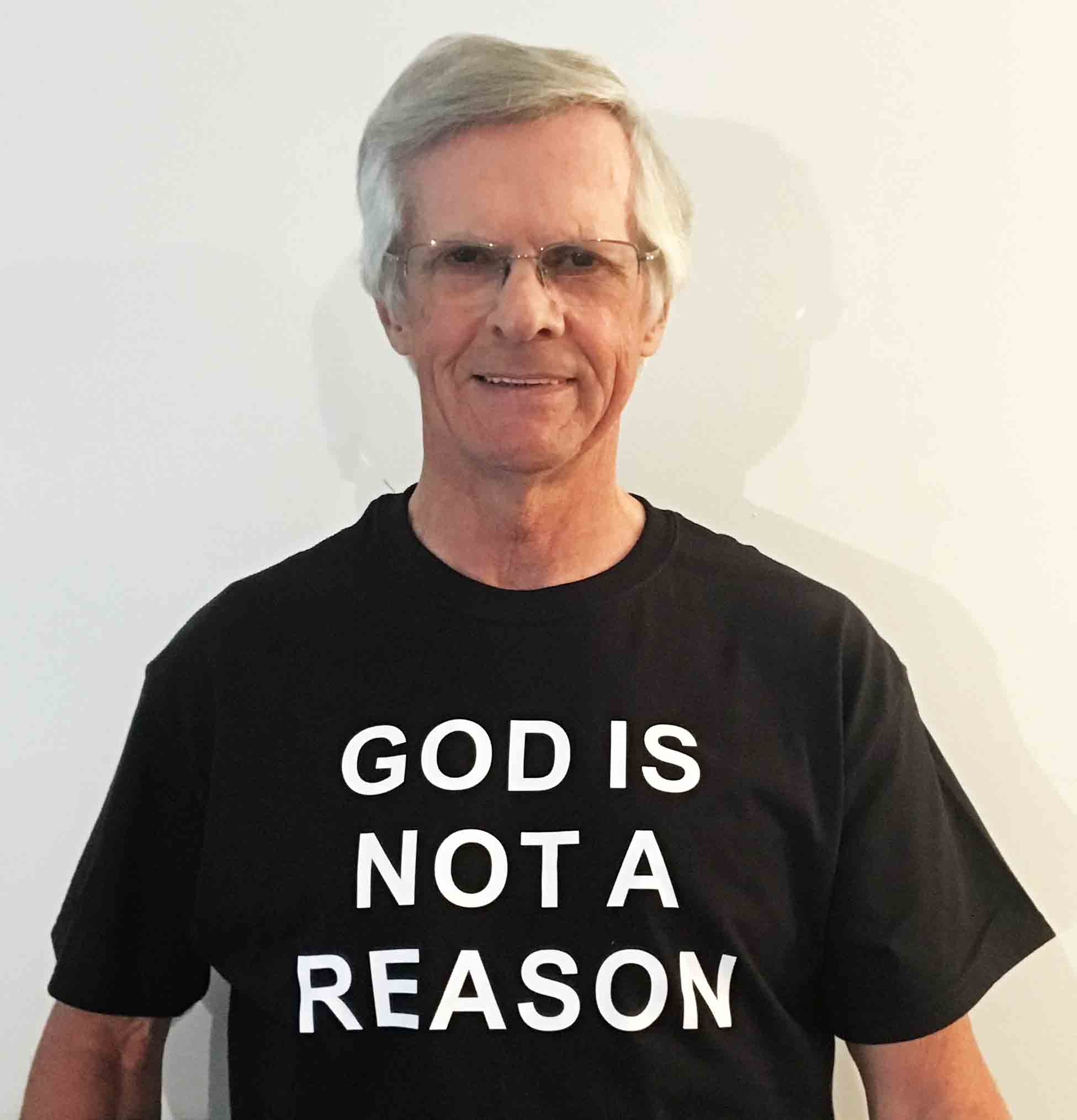 Darwin Bedford wearing his shirt that says 'GOD IS NOT A REASON'